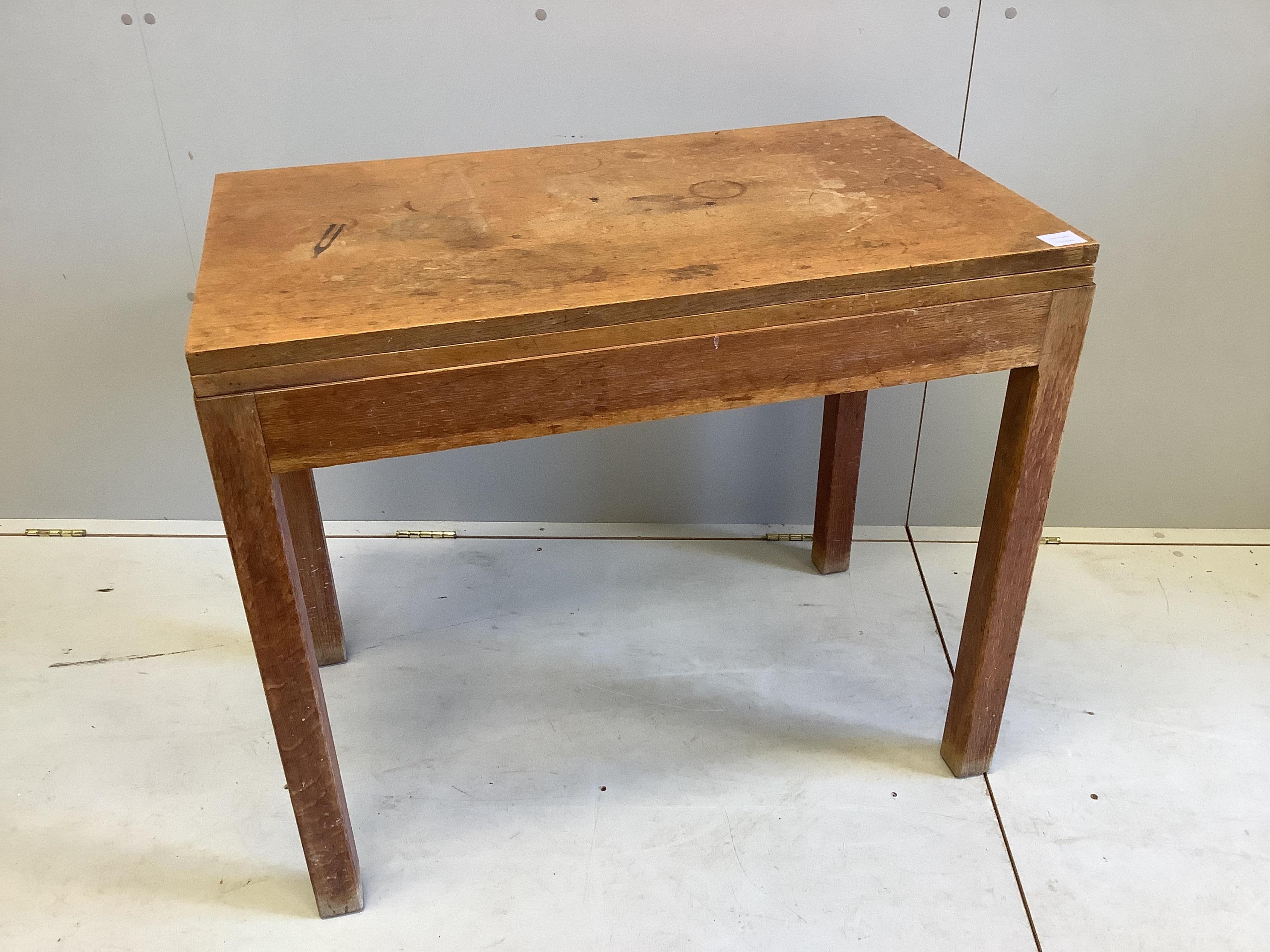 A mid century rectangular oak folding tea table, width 90cm, depth 52cm, height 77cm. Condition - fair